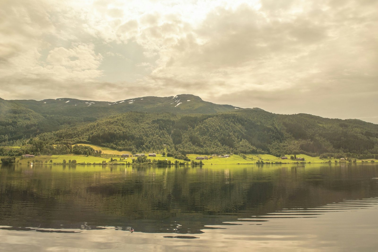 a lake with mountains in the background